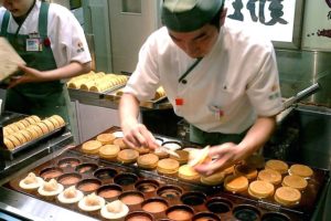 Japanese cook preparing pancakes