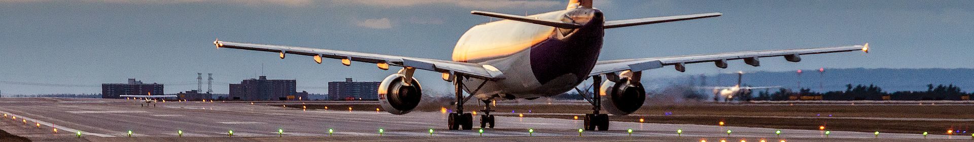 Plane on lit runway