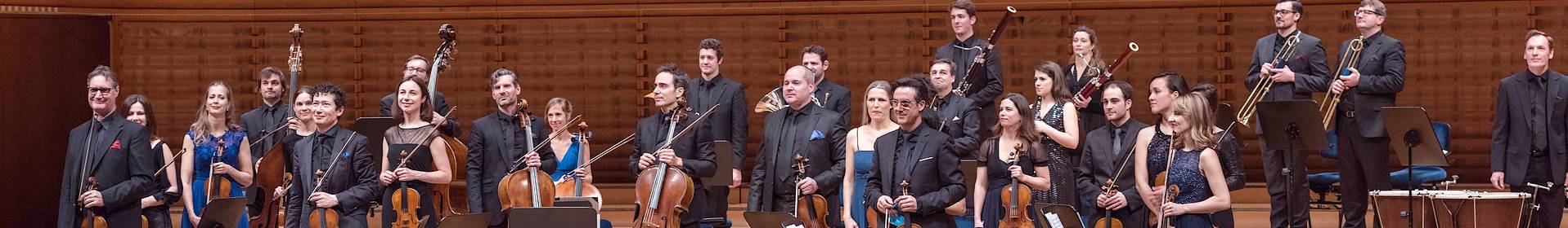 Orchestra members performing on stage