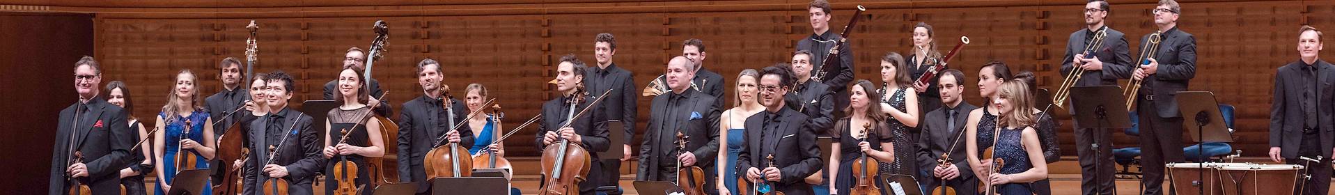 Orchestra members performing on stage